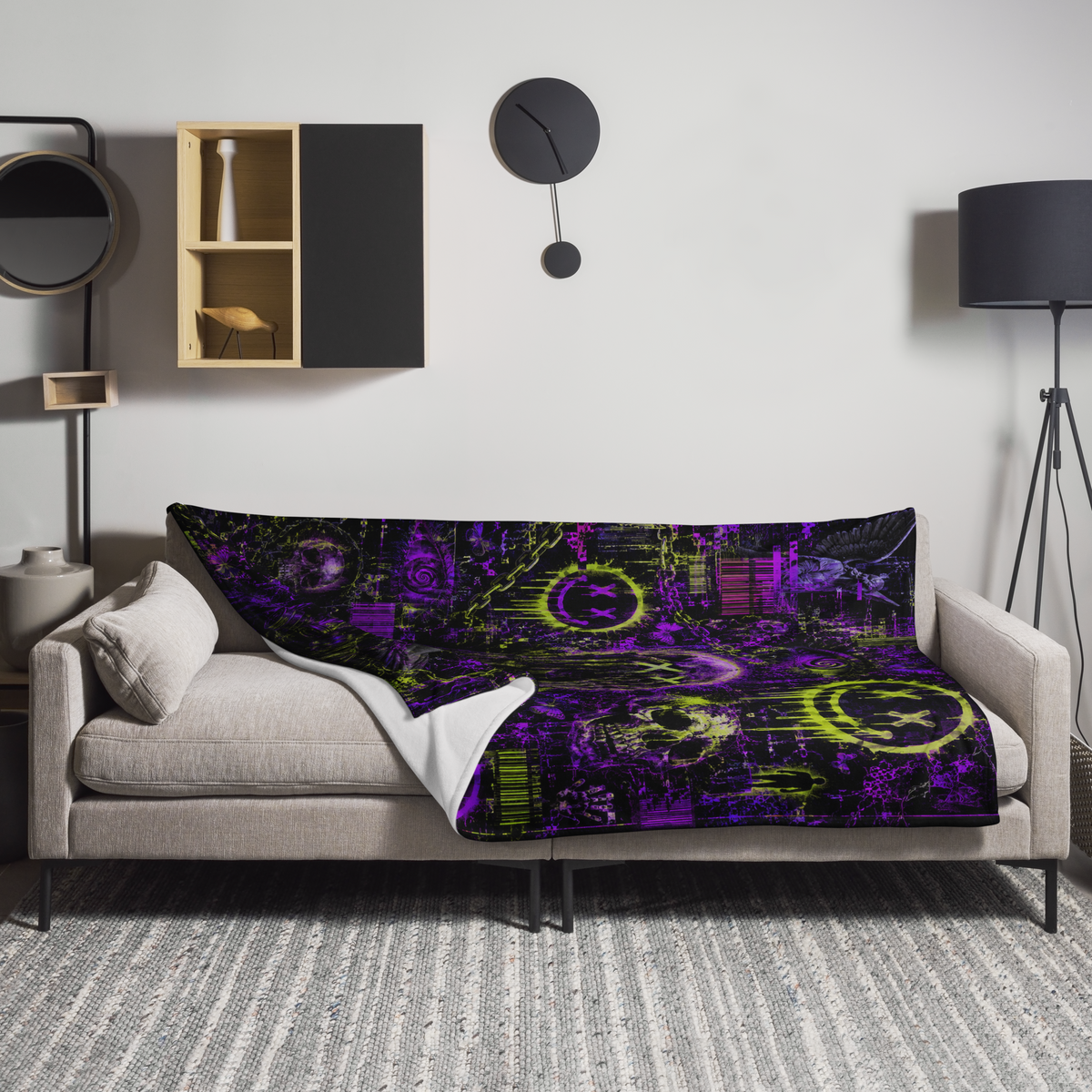 Neon Psychosis glitch blanket draped over a couch with purple, lime, black, and distorted skull artwork.