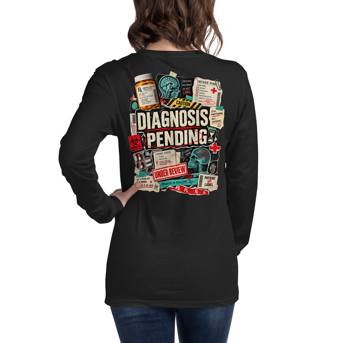 Back of black heather Diagnosis Pending long sleeve shirt with large distressed clinical graphic, brain scans, warning labels, and Under Review details.
